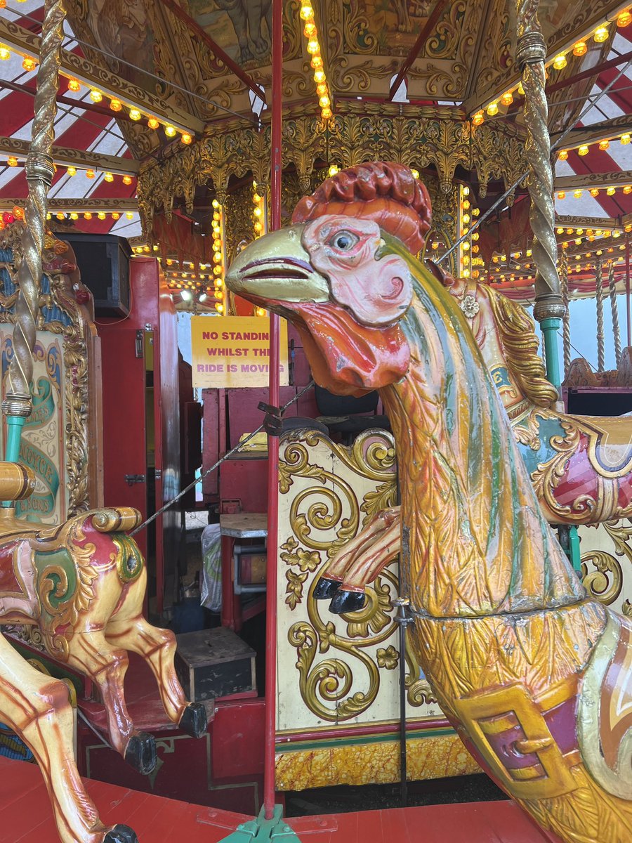 Riding a giant chicken!! 😆 On the carousel 🎠🎡🎪🐔🐓