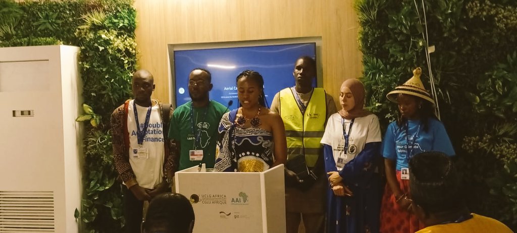 Summer_School1's tweet photo. "In the spotlight at #COP28UAE happening in Dubai is our alumnus, @Zandisile_Howe from Eswatini, her presentation on 'Raising  Adaptation Finance in Africa' went above and beyond, doubling expectations. Join us in urging leaders to recognise youth voices in Adaptation Finance." https://t.co/mXFfmFstzK