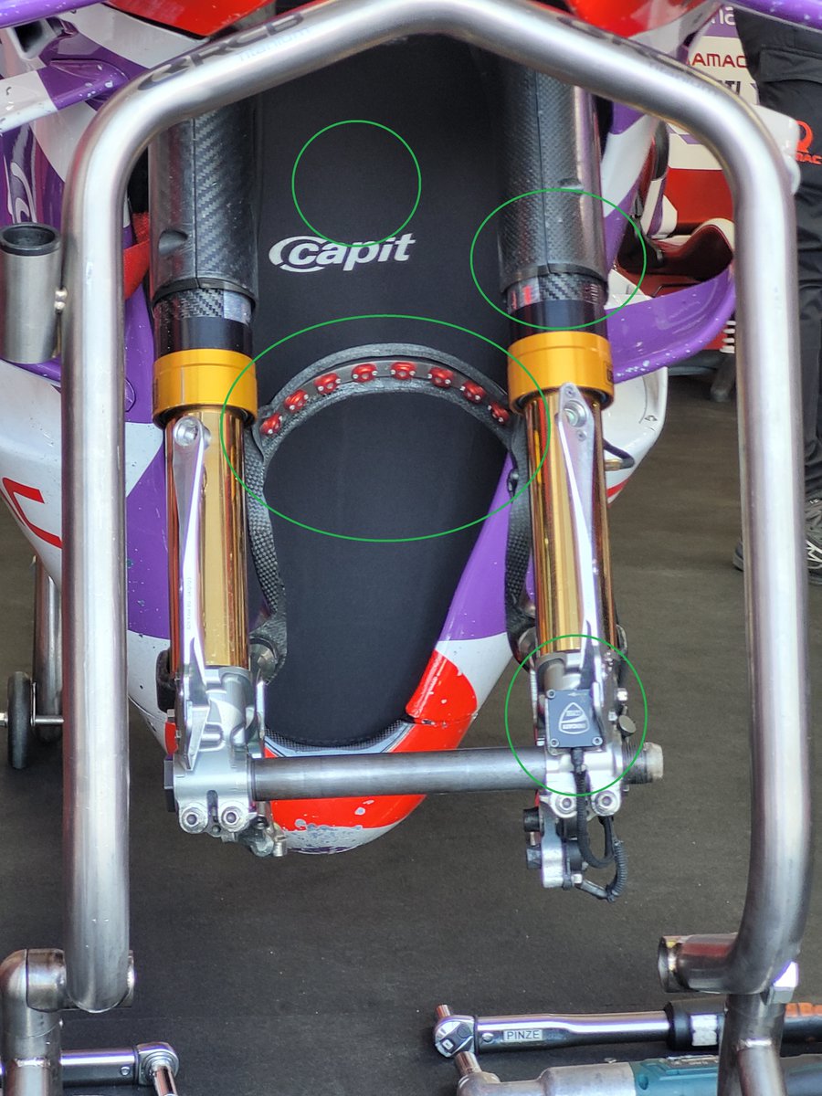 Martin's Duc; green circles from top down: Radiator cover to slow down engine cooling. Oval shaped covers to increase the airflow to cooler. 8 infrared sensors for tire outside temp. 3 axis acc sensor, helps calc susp effectivenes by comparing the acc with a sensor on 3 clamp.