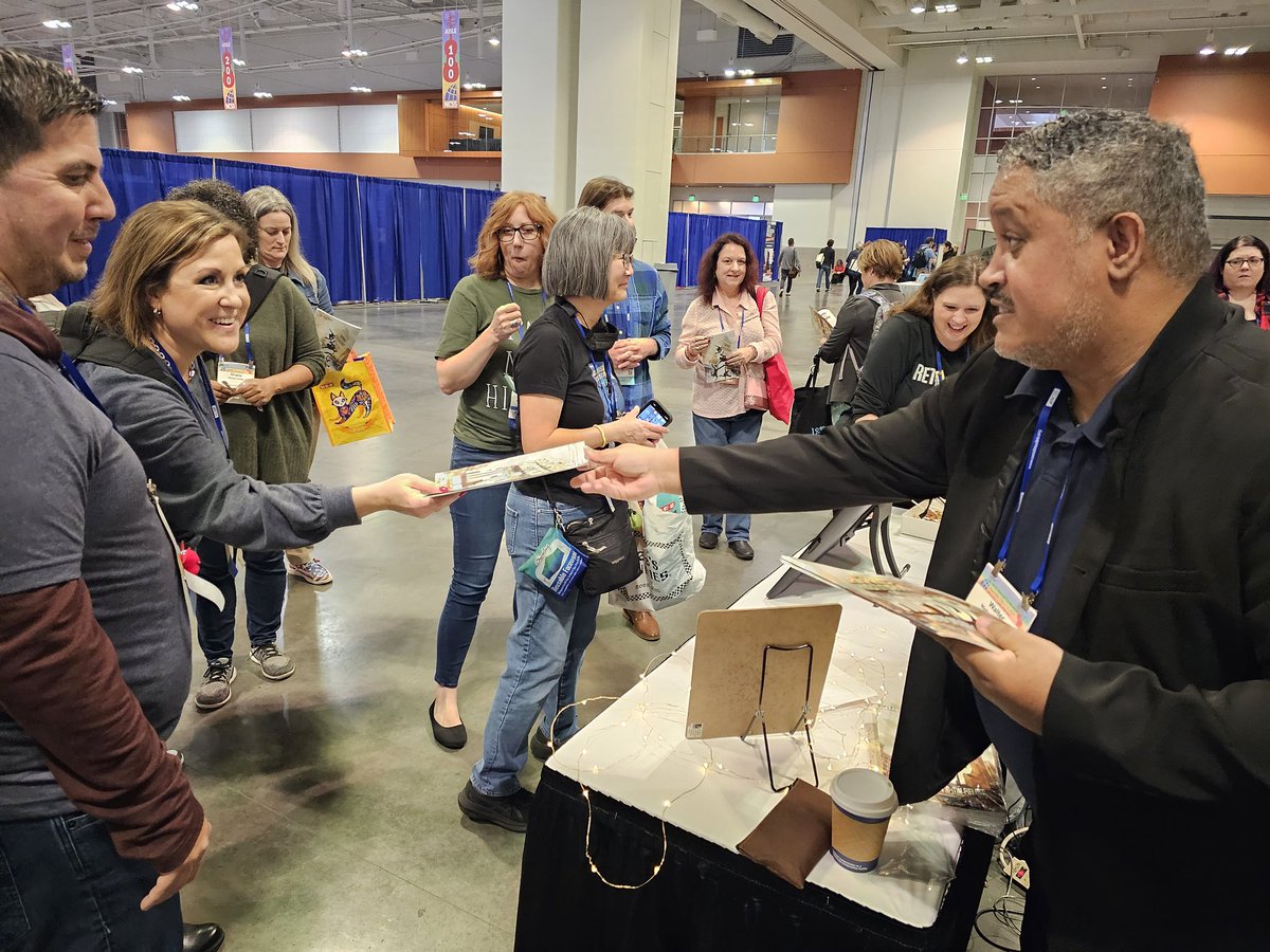 Dr. @WalterDGreason signing copies of his graphic novel. #NCSS2023