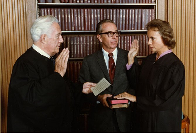 Sandra Day O’Connor is sworn in to the Supreme Court by Chief Justice Warren Burger as her husband John O'Connor looks on. 