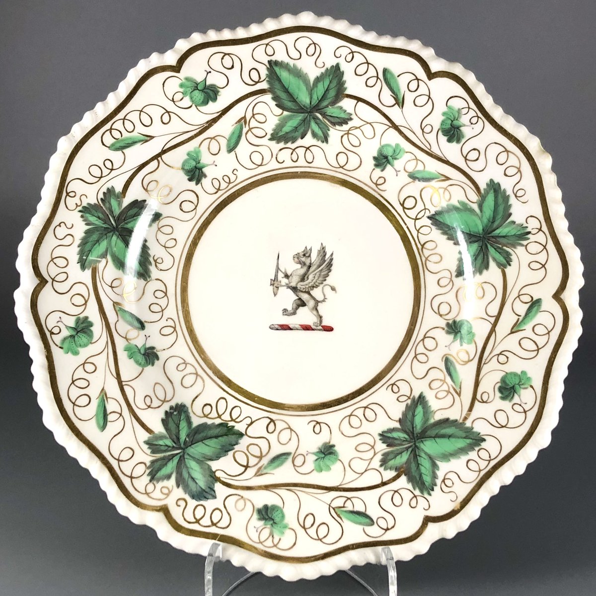 Flight, Barr & Barr armorial plate with moulded gadroon rim. Decorated with a border of vine leaves and gilt tendrils, the centre bearing the crest of a griffin holding a sword. Printed puce marks. Diameter 22 cm. 1813-40. Some restoration. £35 plus UK P&P.