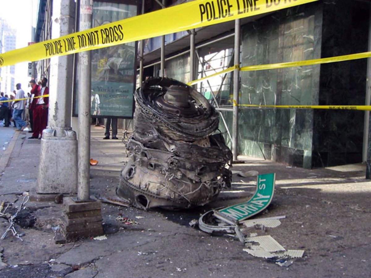 MorbidKnowledge's tweet photo. A piece of debris, likely from one of the crashed airliners, lies on the corner of Murray Street in lower Manhattan near the World Trade Center site in New York on Sept. 11, 2001. https://t.co/Ca17V85nbA