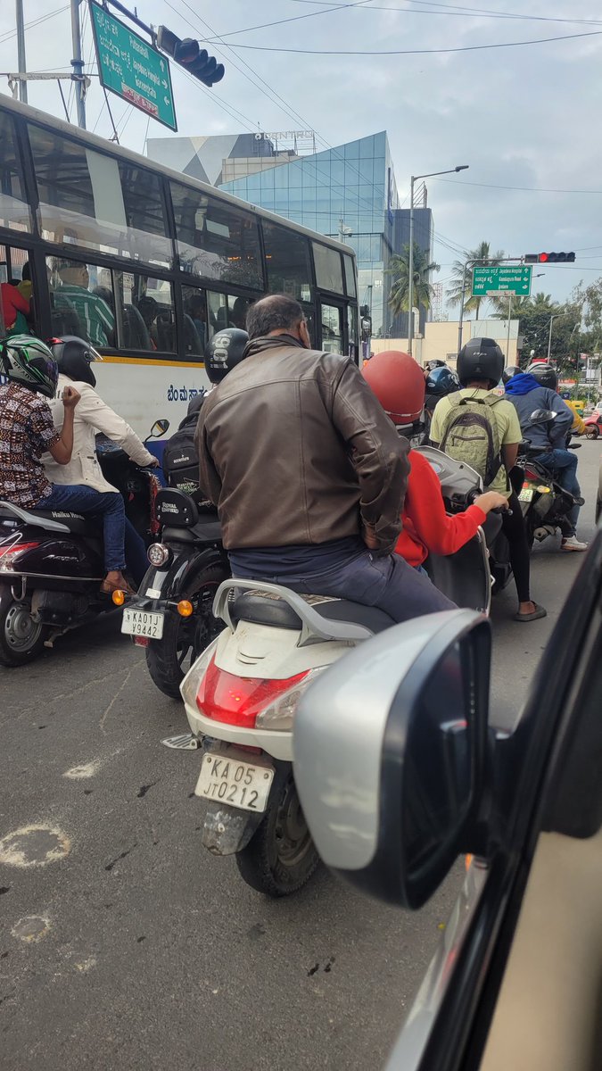 _deedev's tweet photo. @blrcitytraffic @BlrCityPolice Surprised to see how this person is getting passed thru traffic police when a kid around 10-12 yrs is riding a two wheeler. How can an adult become so irresponsible and put the life at risk of a kid ? https://t.co/BjZfkIhYU6