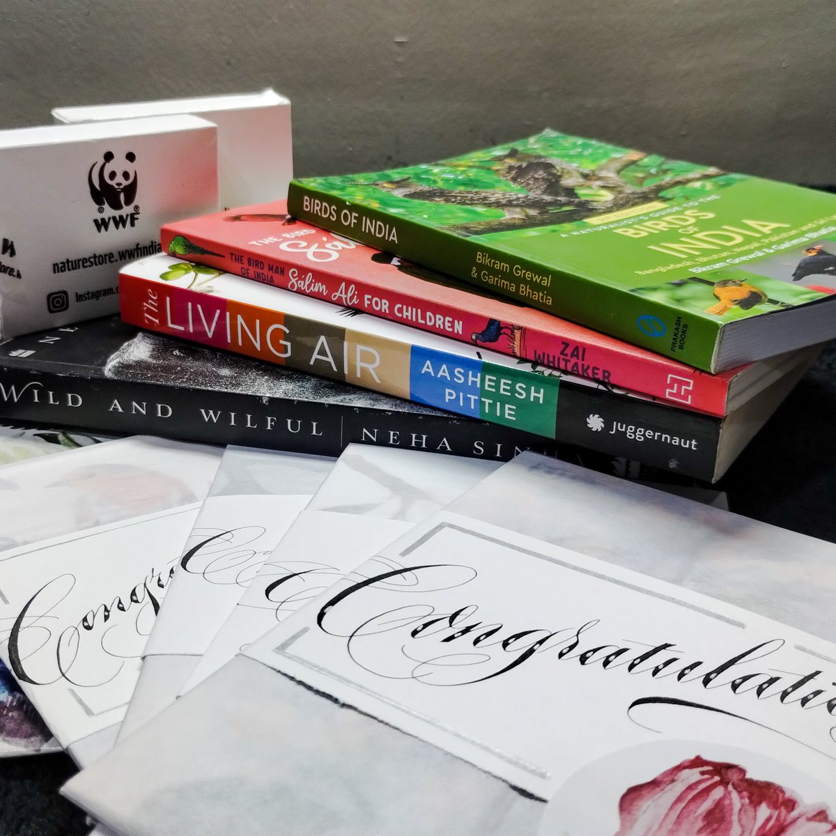 OldWonk's tweet photo. Counting down hours for the felicitation ceremony of #VTBM2023 ⛰️
Here's a sneak peek into what the #VTBM_Champions are taking home — Best sellers by @nehaa_sinha @indiancourser goodies from @WWFINDIA handmade congratulatory cards by Aditi (Insta: the_doodle_factory) and more! https://t.co/0T6AKmJ08G