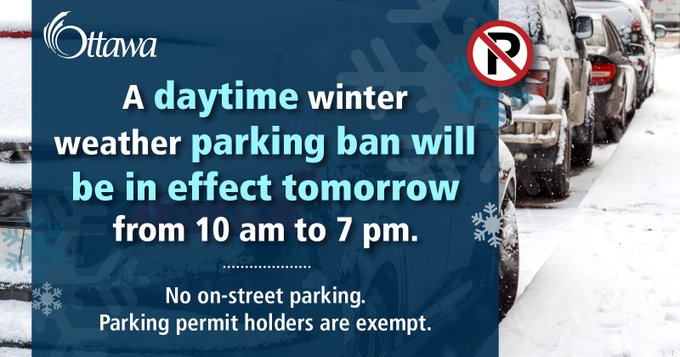 A background photo of several cars parked on the side of a snowy street. In the foreground there is a large blue text box with snowflakes and text that reads "A daytime winter weather parking ban will be in effect tomorrow from 10 am to 7 pm. No on-street parking. Parking permit holders are exempt."