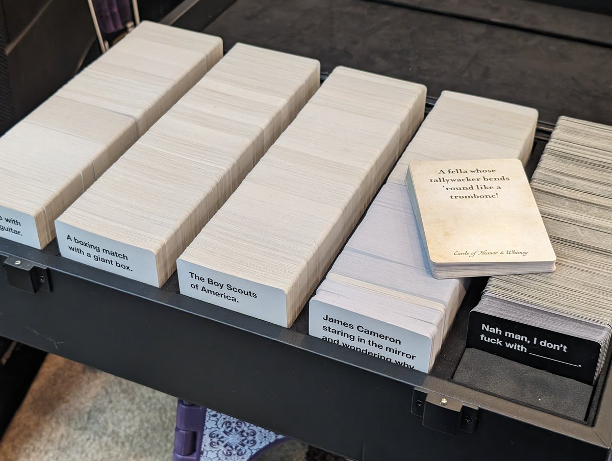 Neopifex's tweet photo. Hey @CAH, my Bōks is nearly full. Will there ever be a bigger Bōks, or am I going to have to start double-fisting CAH briefcases? https://t.co/x7jJThm2gY