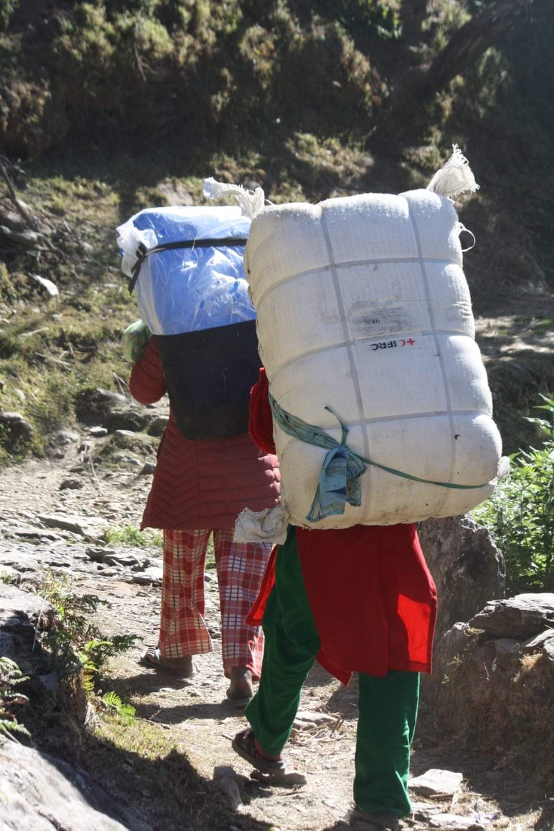 NepalRedCross's tweet photo. Nepal Red Cross Society is putting every effort to deliver relief and support to people affected by #KarnaliEarthquake. Red Cross volunteers and hired potters carrying relief items in communities of Kushe Rural Municipality of Jajarkot which are out of road access. https://t.co/lXqGq6hCbd