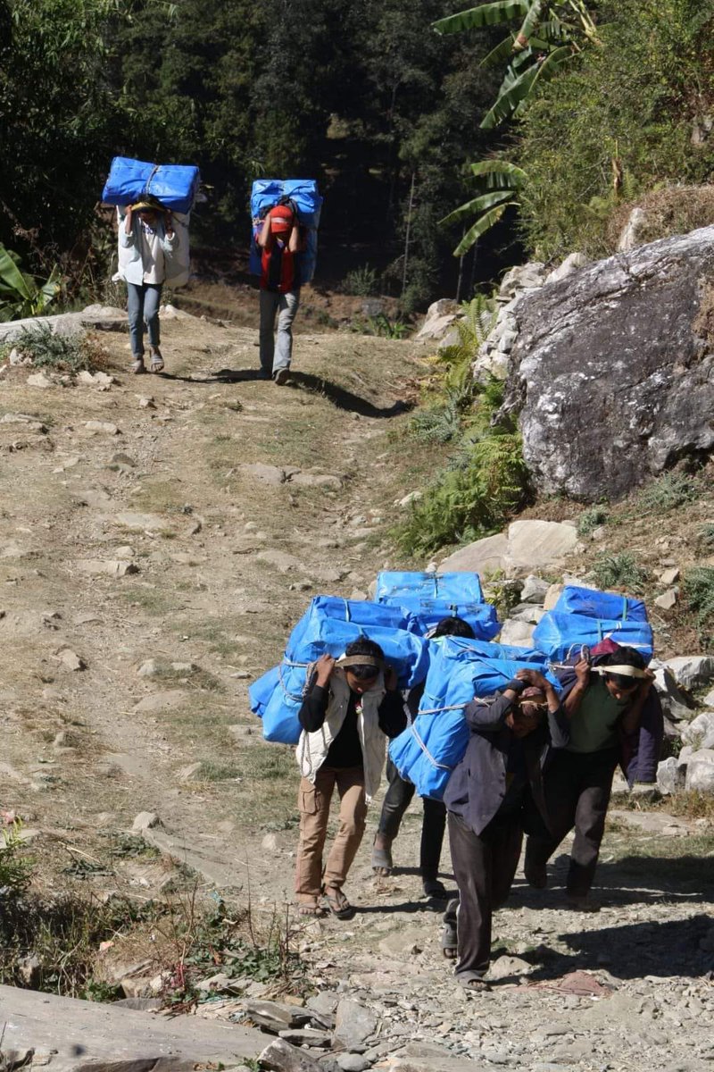 NepalRedCross's tweet photo. Nepal Red Cross Society is putting every effort to deliver relief and support to people affected by #KarnaliEarthquake. Red Cross volunteers and hired potters carrying relief items in communities of Kushe Rural Municipality of Jajarkot which are out of road access. https://t.co/lXqGq6hCbd