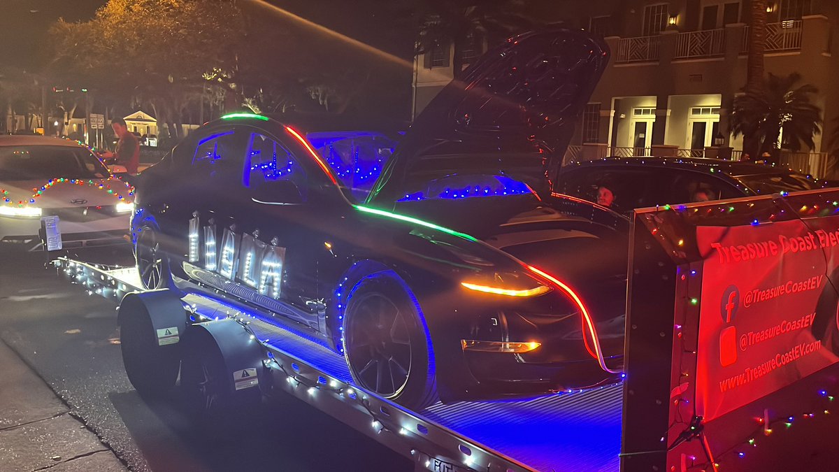 TCPalmAdamNeal's tweet photo. A @Tesla #Model3 continually playing the #TeslaLightShow (with added lights) was the Treasure Coast #ElectricVehicle Club’s “float” during the annual #VeroBeach Christmas Parade. Even @elonmusk may give a nod to this creativity. #EV https://t.co/GfLhwo1r6E
