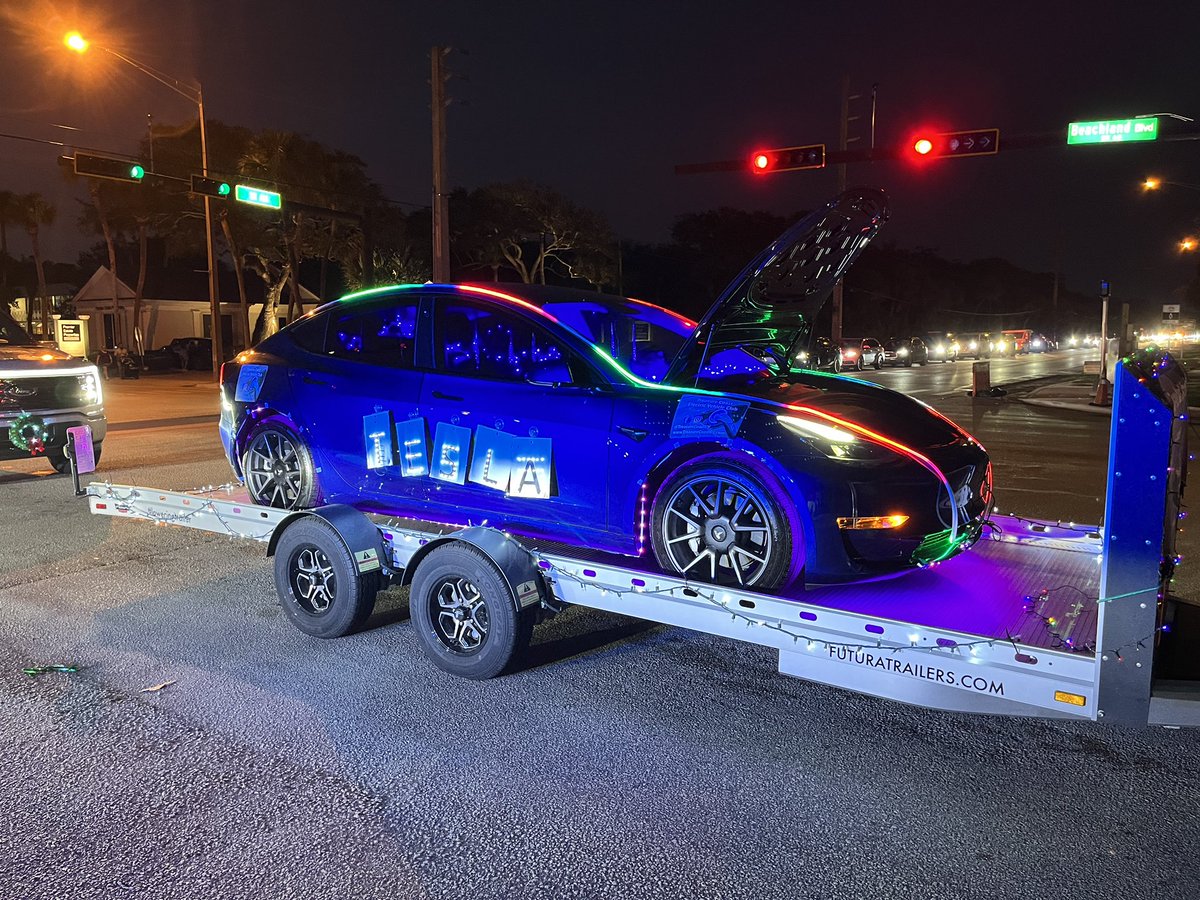 TCPalmAdamNeal's tweet photo. A @Tesla #Model3 continually playing the #TeslaLightShow (with added lights) was the Treasure Coast #ElectricVehicle Club’s “float” during the annual #VeroBeach Christmas Parade. Even @elonmusk may give a nod to this creativity. #EV https://t.co/GfLhwo1r6E