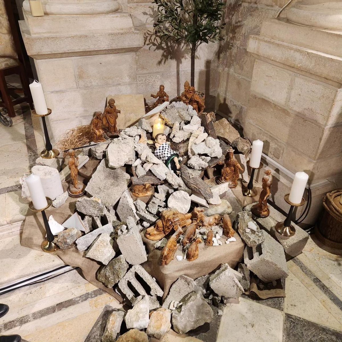 ShaneClaiborne's tweet photo. This is the Nativity in Bethlehem this Christmas. Jesus is buried in the rubble. 

—

“Christmas in Palestine this year. The Child under the rubble. Immanuel God is with us in our pain and suffering. God in solidarity with the oppressed. The child of Bethlehem is our hope. For the children of Gaza and all victims of wars. 

In Gaza today, God is under the rubble. He is in the operating room.  If Christ were to be born today, he would be born under the rubble.  We see his image in every child killed and pulled from under the rubble. In every child in incubators.” -@MuntherIsaac
