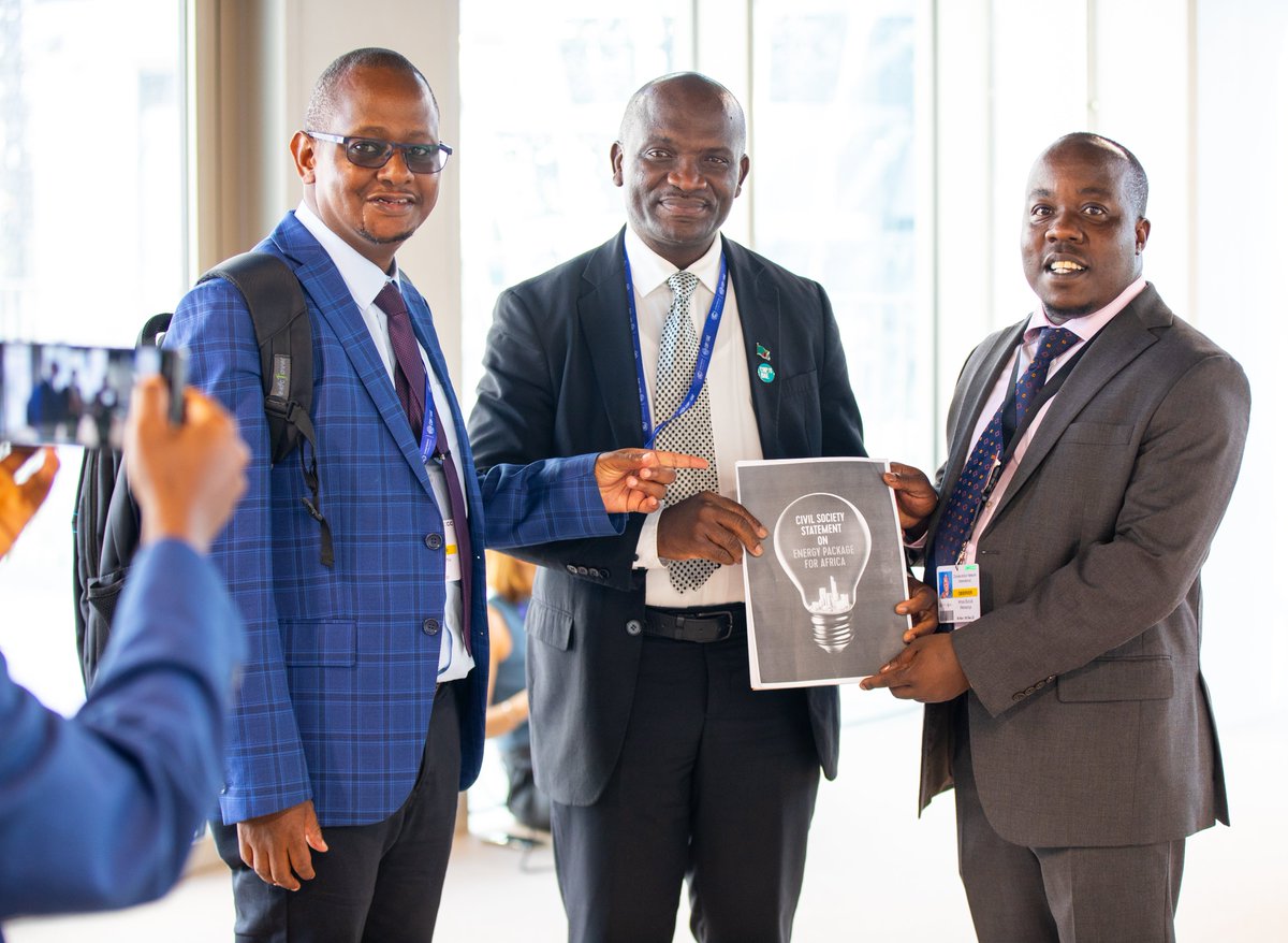 Amos Wemanya, the Lead, Just Transitions at Power Shift Africa, presents Ephraim Shitima, Chair, Africa Group of Negotiators, with a copy of the civil society statement on #renewableenergy targets for #Africa at #COP28 in Dubai.