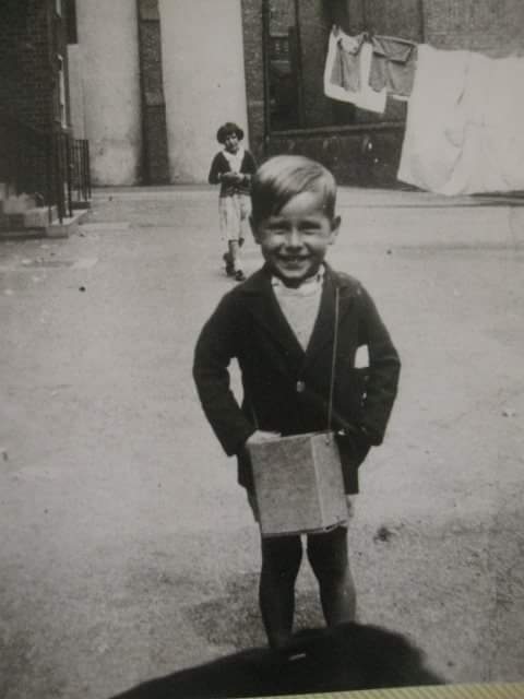My uncle Roy, carrying his gas mask outside, Brownlow, Dickens Estate. #bermondsey