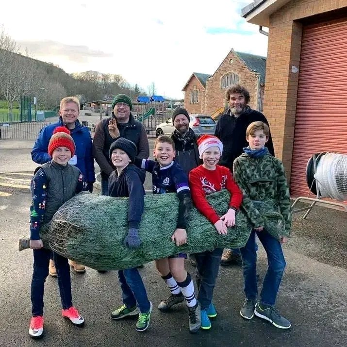 A family very happy that they received their own beautiful Christmas tree saved delivery at door steps place your order 🌲🌲🌴