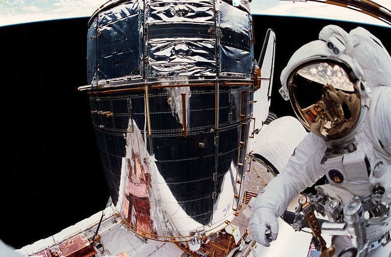 📸 👀...an image of a reflection of an astronaut taking an image in front of a space telescope that has taken over a million of the universe since its launch in 1990.