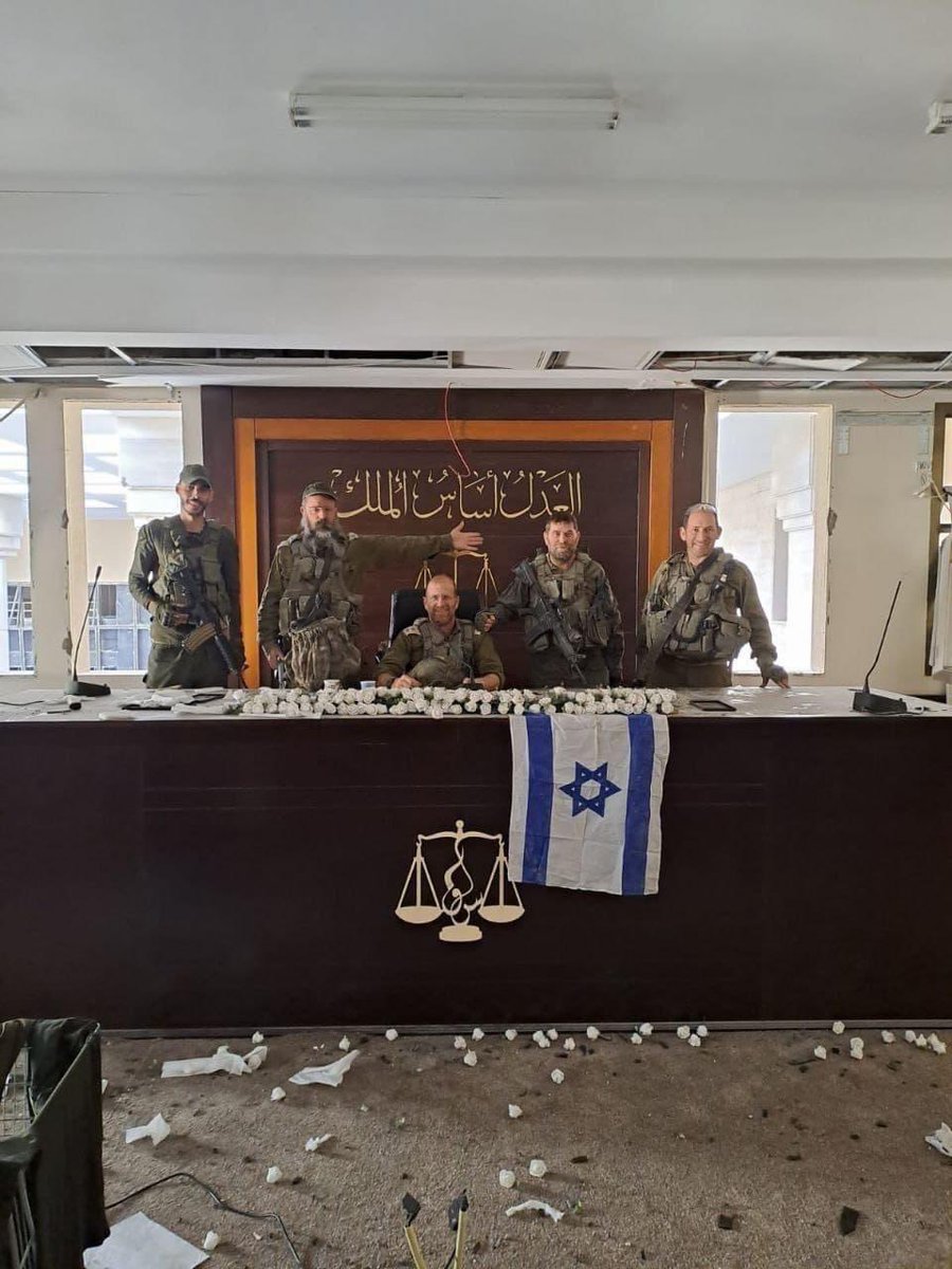 IDF combat soldiers took a pic in the Hamas supreme court in Gaza moments before it was demolished..