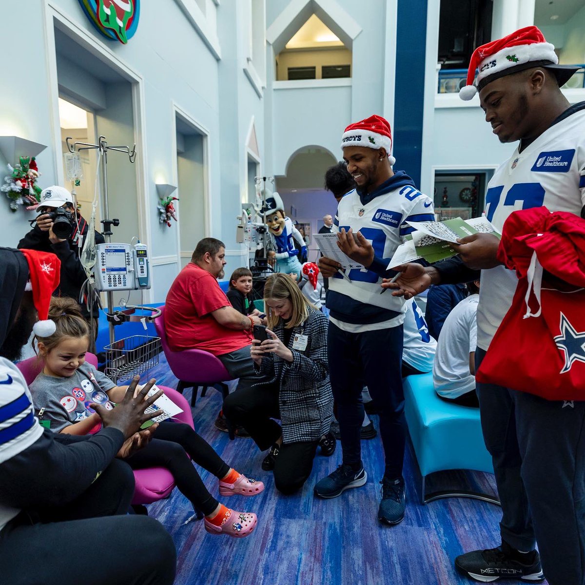 A huddle full of holiday magic 💙✨ Today, we kicked off the holidays with some of the most resilient, courageous & extraordinary members of #CowboysNation. #FootballisFamily | @UHC