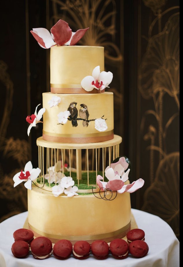 Gold painted wedding cake with sugarflowers