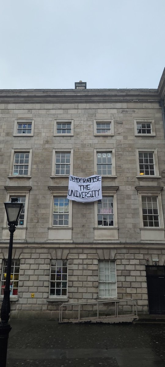Students from @S4C_group @S4C_TCD drop banner @tcddublin 'Democratise the University' in solidarity with @PWO_TCD @PWO_Ireland protest for postgraduate researchers' workers' rights.