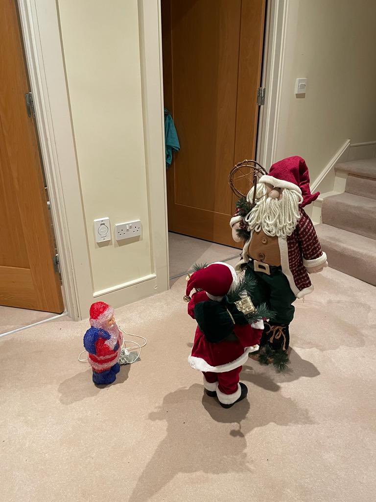 My son rearranged the decorations, so now the Santas are having a union meeting.