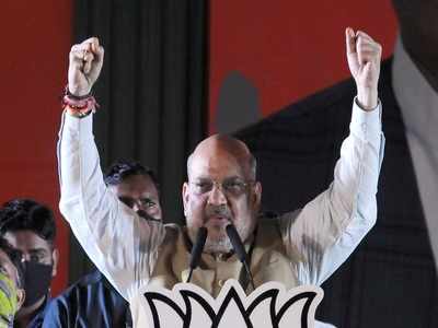 Amit Shah holds roadshow in Bengal's North 24 Parganas district

BJP supporters cheered for Shah, as his caravan inched forward through the crowded streets of Amdanga -- from Mitre Vijay More to Neelganj More. The home minister showered flower petals on his supporters and the