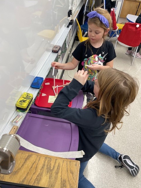 Our Grades 2-3 continue to explore forces and structures by seeing who can make a straw framework that supports the most books stacked on top of it.
