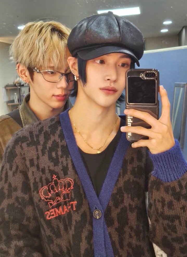 In the reflection of friendship, these two boys find joy in taking photos together, creating a mosaic of memories in front of the mirror.