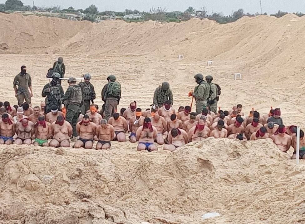 The civilian men who were kidnapped from the school have been taking to an open field for what looks like an execution line up. They likely were taken from Khalifah Bin Zayed school which is housing ~10,000 displaced Palestinians, & came under bombardment and siege this morning.