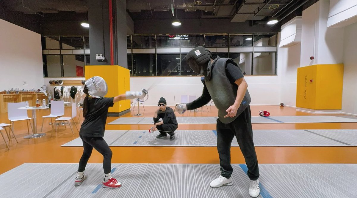 Jackson with his father and his niece Aimee, fencing. Three generations of fencing in this Wang family.