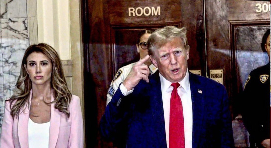 realsandibachom's tweet photo. I filmed Trump today in the hallway of the courthouse of his fraud trial for the fifth time.  He’s absolutely insane. Every single time he says, the same thing over and over again, and plays the air accordion.  #witchhunt https://t.co/pDdyYhwvrL