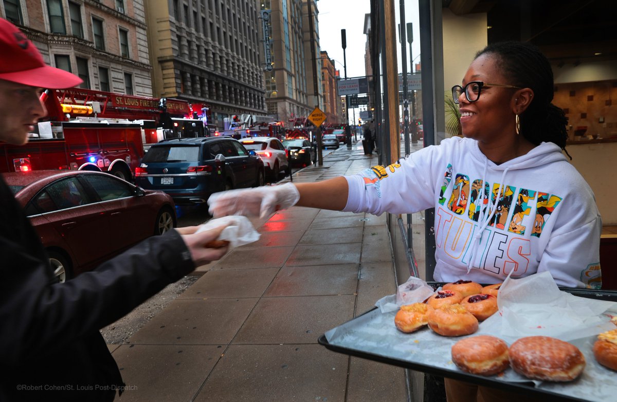 Danielle Daniels of Pharaoh's Donuts handed out treats to Mark Twain Hotel residents and @STLFireDept firefighters after a fire caused by a smoking resident temporarily evacuated the downtown #STL building. Always look for the helpers.