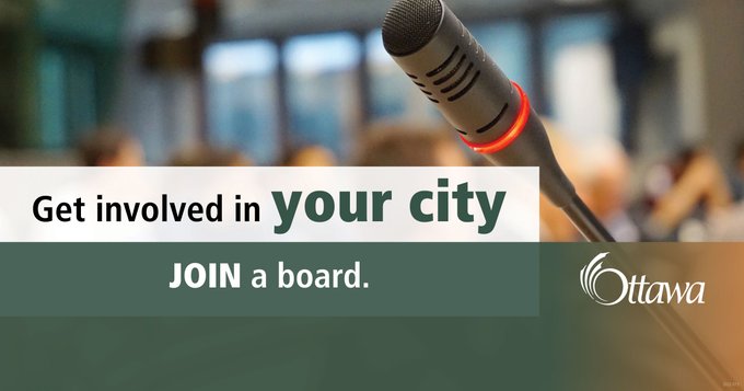 A microphone is shown on the right side of the photo. In the background, blurry figures can be seen. In a white text box at the centre of the photo is written “Get Involved in your city” and in a green text box below, “Join a board" is written in white.” 