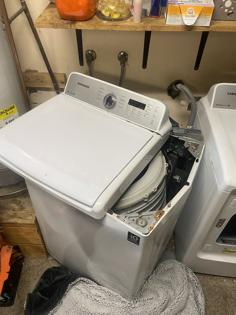 JosephHanley18's tweet photo. Samsung washing machine exploded. Sounded like a box truck rolled over in front of our house. I went out to see what the sound was. Found the drum broke loose and blew the top of the washer into the side of our hot water heater. Luckily it didn’t take out the gas line. #Samsung https://t.co/6nOVwU3AWp
