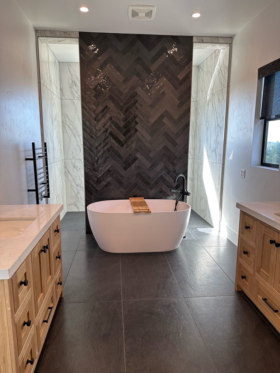 With proper lighting and a contrasting pallet, you can achieve a balanced space while using dark tiles. Our Ardesia floor tile and Flash Graphite give dark drama while light colors everywhere else balance the rest of the space. Click here to learn more: ecs.page.link/qeUJp