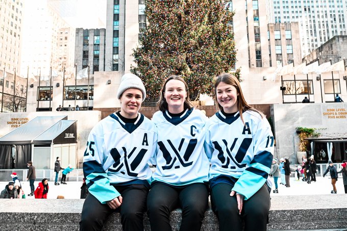 PWHL New York Captain Micah-Zandee Hart and Alternate captains Alex Carpenter and Ella Shelton posing for a photo at Rockefeller Center