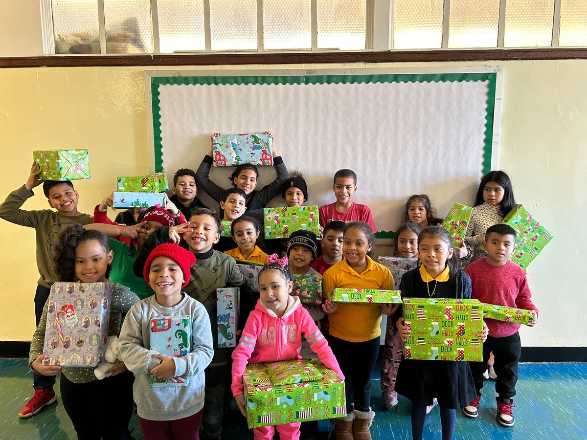 Ms. Devanny’s students receiving a gift from Santa.