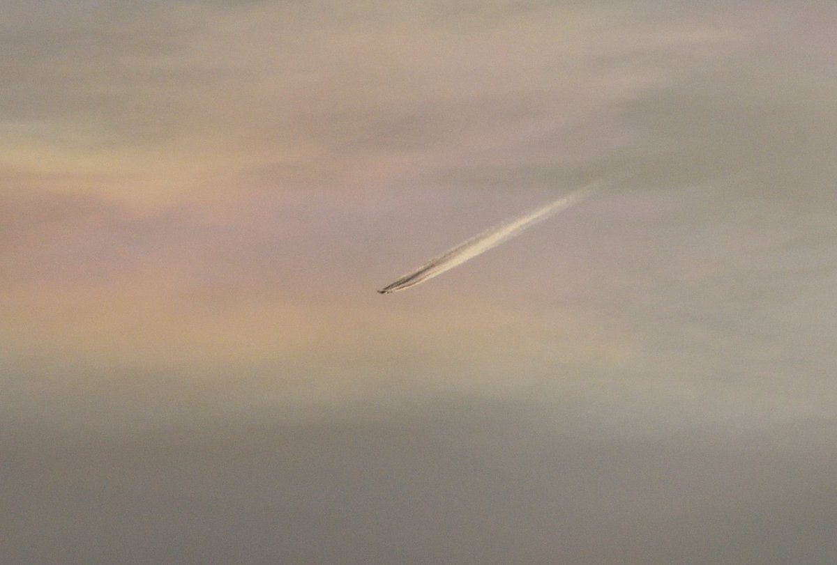 A Lufthansa Boeing 747, reflecting the sun still below the horizon to the observer in the first pic, passing by some nacreous clouds this morning over Perth.