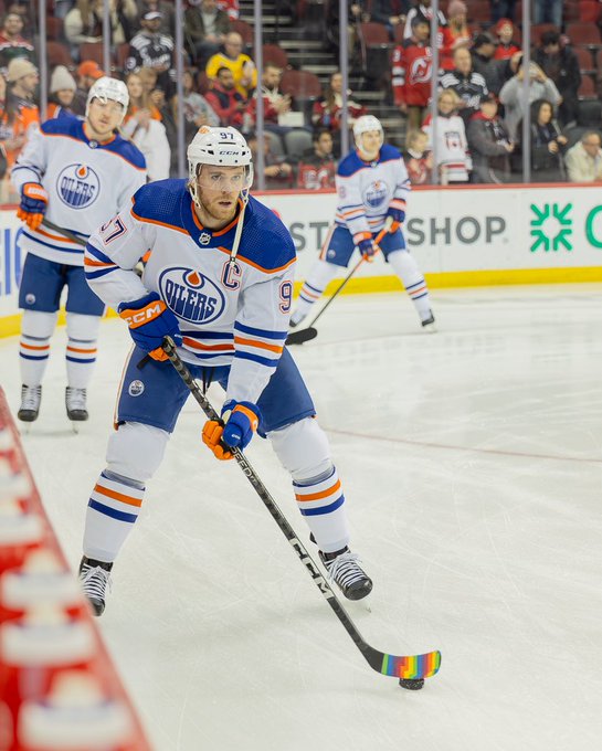 Connor McDavid on the ice for warmup in New Jersey with Pride Tape on his stick