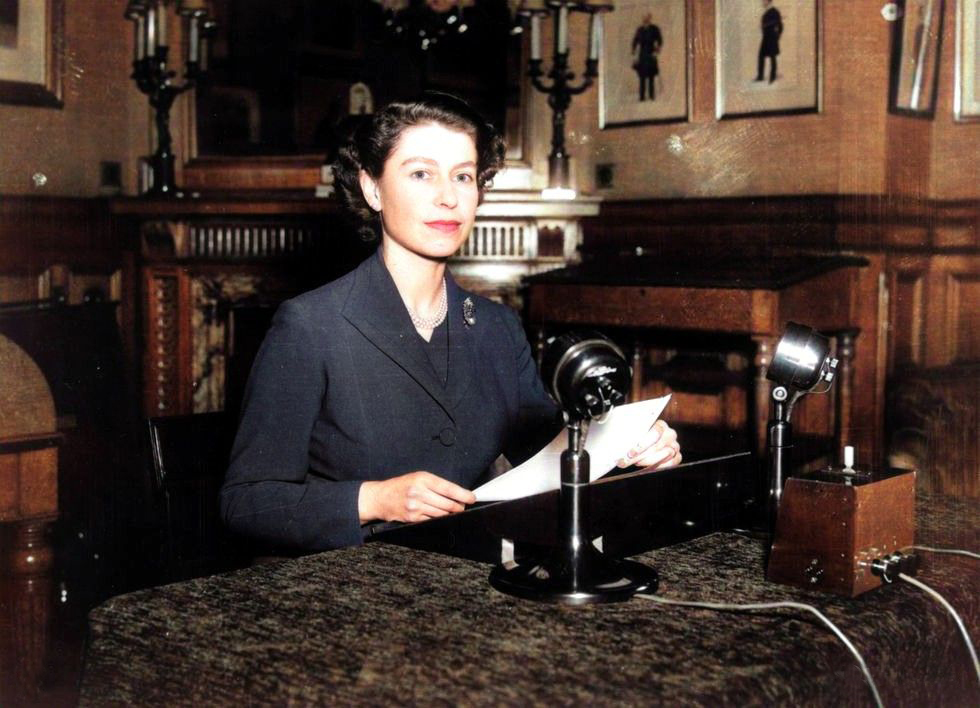 Queen Elizabeth sits by the microphone, paper in hand, to prepare for her very first Christmas address to the nation in 1952. #queenelizabeth #queenelizabethII #thefifties #the50s #queensspeech #colourised