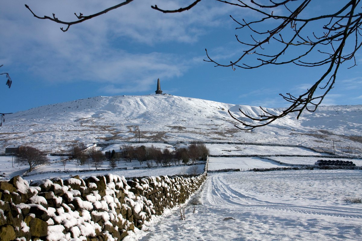 Stoodley Pike Monument dominates the skyline above Todmorden, sitting at the summit of  Stoodley Pike, a 1,300-foot (400 m) hill It was designed in 1854 by local architect James Green, and completed in 1856 at the end of the Crimean War.