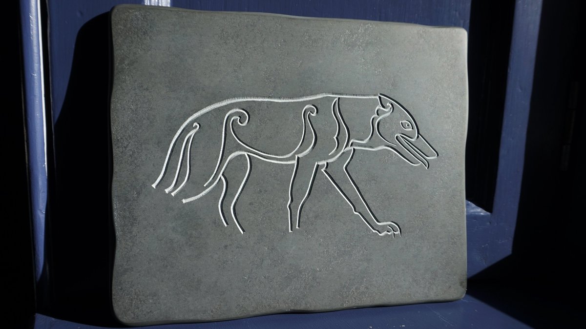 V-cut slate Ardross Wolf (27 x 22 cm). A small replica of the Pictish carving that was discovered built into a farm wall in the 1860s. Original is now housed in Inverness Museum and Art Gallery. Made for Groam House Museum schools outreach program.