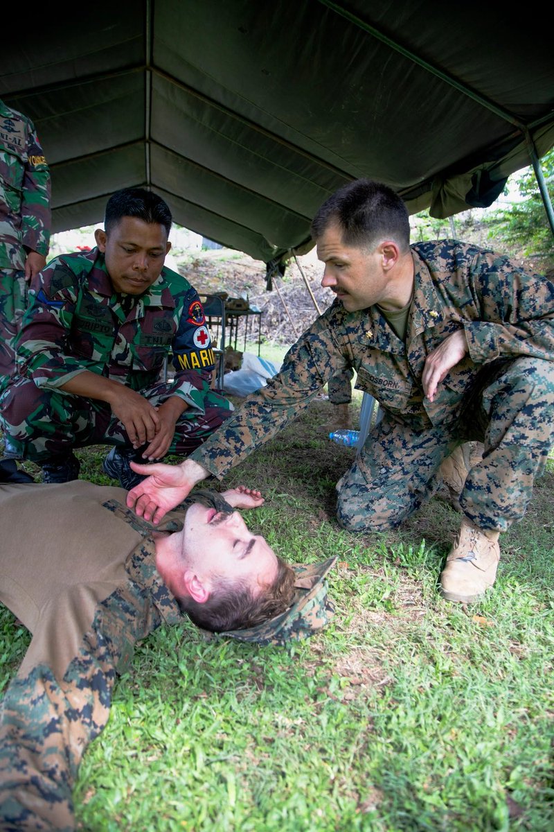 Medic! U.S. Navy Lt. Cmdr. Jeffery Osborn the senior medical officer with Marine Rotational Force-Southeast Asia, I Marine Expeditionary Force, explains a simulated triage to an Indonesian marine with 4th Marine Infantry Battalion, Pasmar 1, during Keris Marine Exercise 2023.