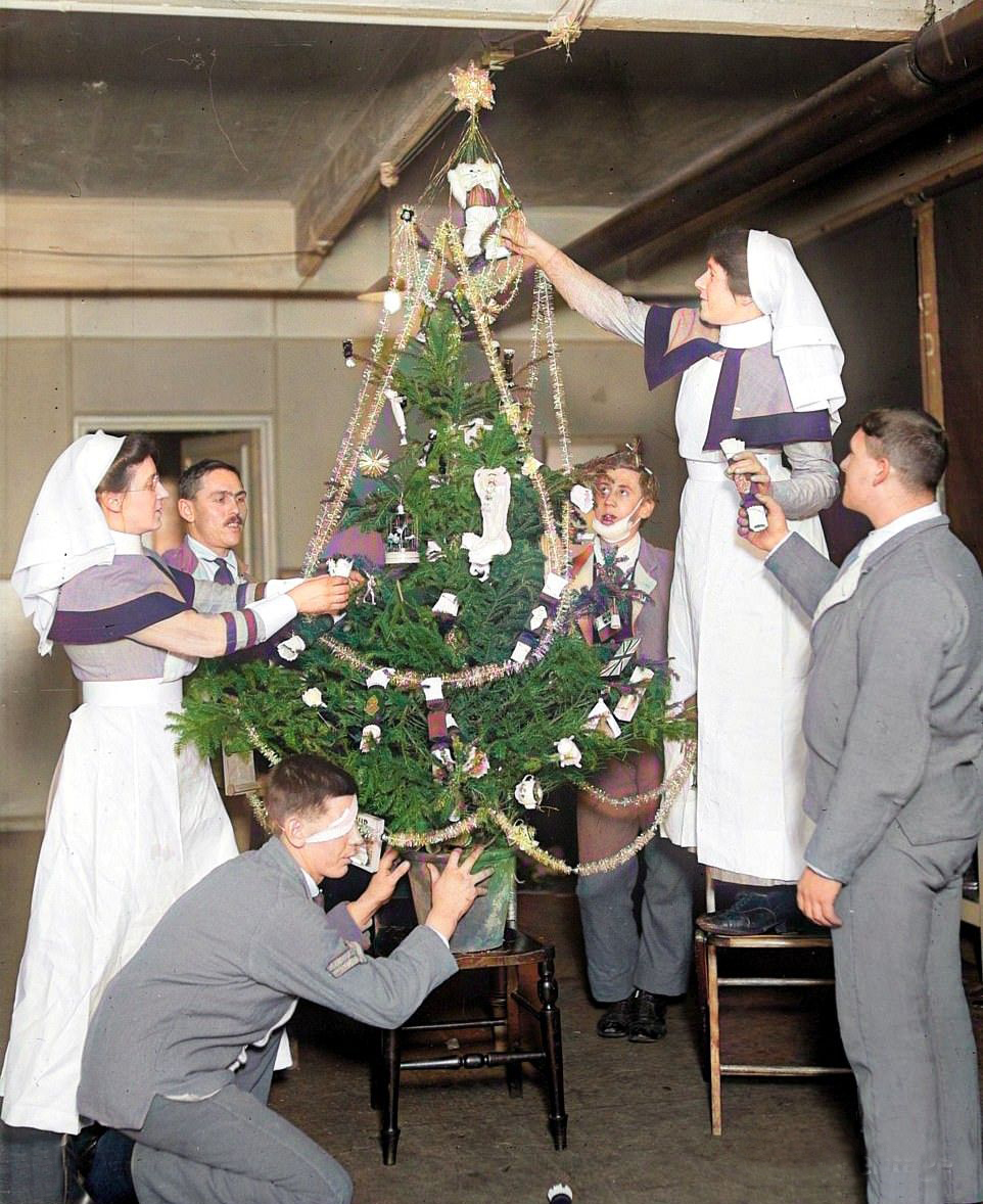 Staff and patients decorate a Christmas tree in King George's Military Hospital, Waterloo, London in 1916. #militaryhospital #waterloo #colourised #christmastree #christmas