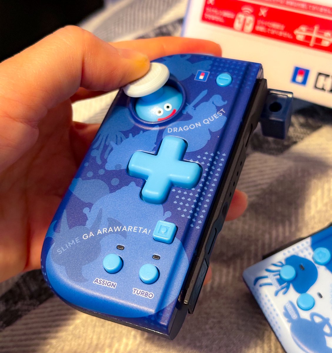 My new Dragon Quest controllers came in for Nintendo Switch. LOOK AT THE SLIME PLAYING PEEKABOO. 🥹