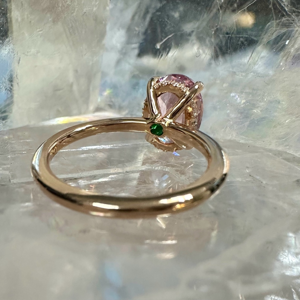 Our bespoke Billie ring holding a stunning Padparadscha sapphire in 18k rose gold, with a row of sparkling diamonds in a hidden halo design, and a hidden emerald birthstone set under the centre stone. 
lizunova.com

#australianjeweller #sydneyjeweller #sydneylocal