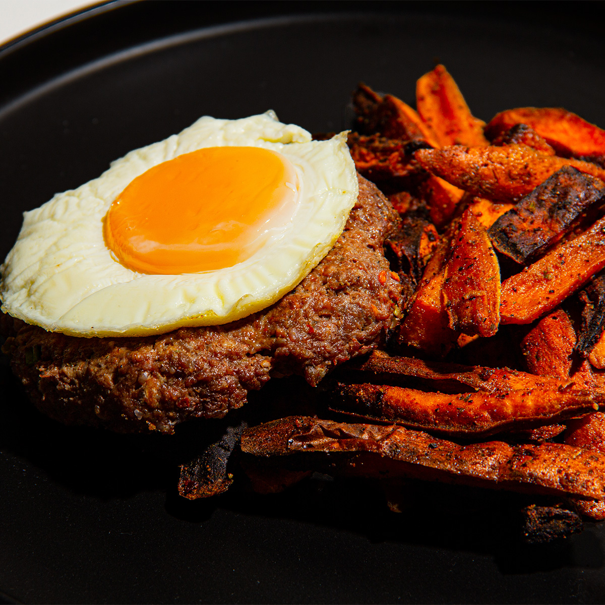 Craving a breakfast that's unforgettable? Try our Bison Breakfast! A ground bison patty on a bed of seasoned sweet potatoes, celery, and green onion, topped with an egg. It's not just for mornings - enjoy its 37g of protein, gluten &amp; dairy-free goodness any time!