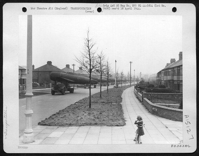 👀 Not an everyday occurrence.   

USAAF P-47s being transported down a street in Liverpool, on their way to an English Airfield in 1944.   

From the US Nat. Archive.🧐