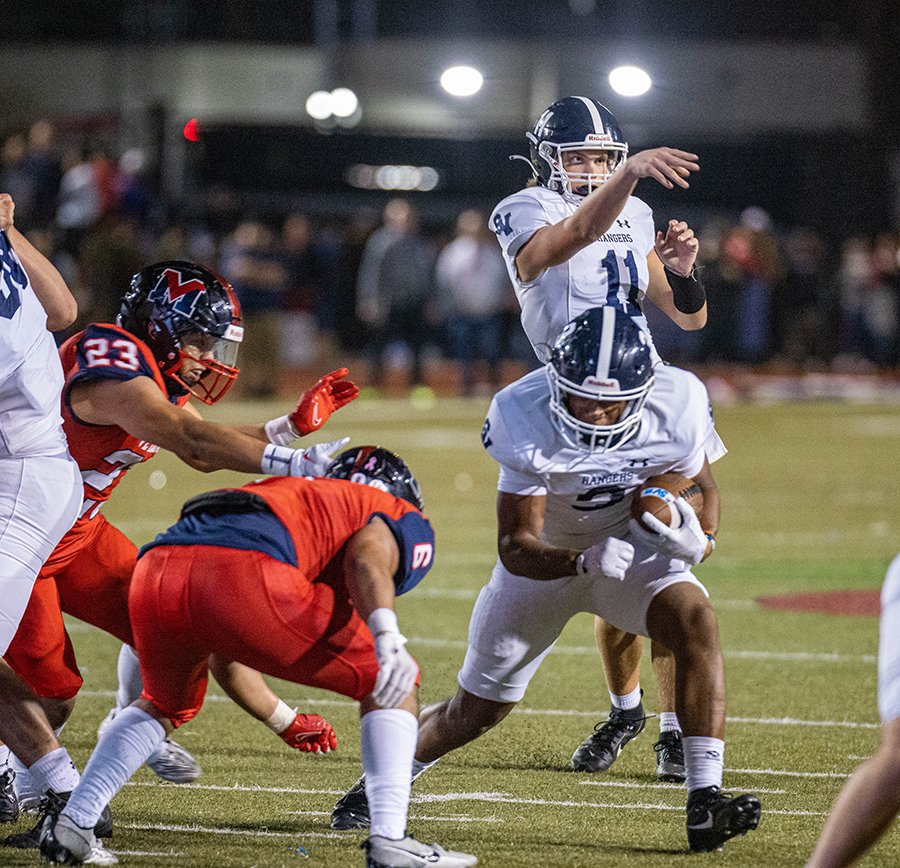 YOUNG GUNS -  Freshman QB Ty Knutson fakes a pass and freshman RB Caleb Peagler runs inside during the state semifinal. Knutson had five passes with four completions and 34 yards. Peagler rushed 20 times for 89 yards and one TD.   Photo by @danielcaptured