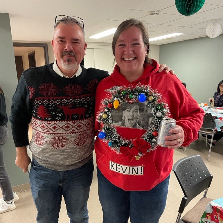 Yesterday Partners &amp; staff participated in our holiday potluck/ugly sweater contest. Winning the sweater contest was Angie, who loves her fellow partners so much that she wore their smiling faces to work! Close second was Alison, with her creative Home Alone “Kevin!” sweater.
